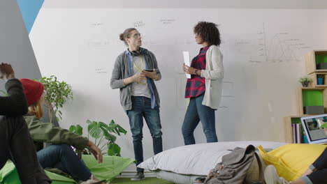 young african american business woman teaching group of students showing project timeline on whiteboard presenting graph data diverse team brainstorming sharing ideas in office lecture