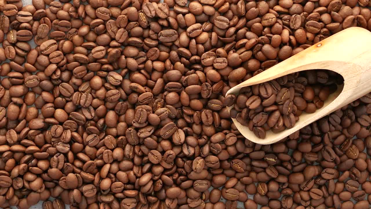 Fagioli di caffè con cucchiaio di legno