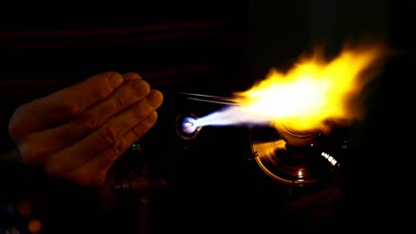 close up man working with glassblower torch flame