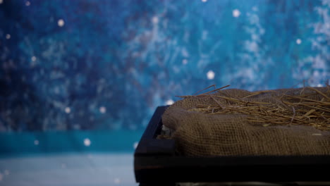 a sliding view of a manger sitting in a starry night sky at christmas time