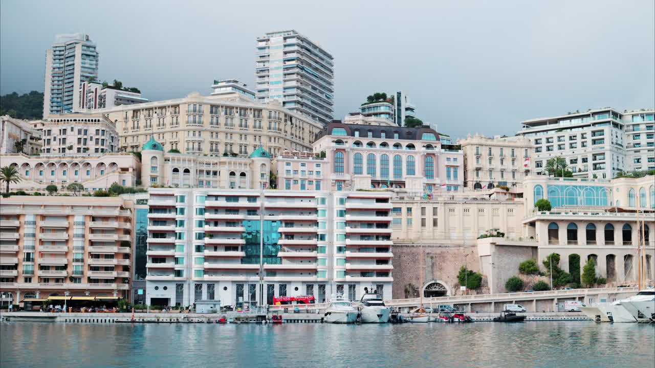 View of boats docked in the Monaco Marina with the skyline of the city on the background