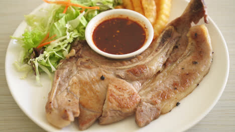 grilled pork chop steak with thai spicy dipping sauce or jaew sauce - fusion food style