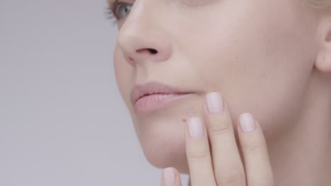 macro close up beautiful healthy woman touching skin slow motion for beauty skincare concept on a grey background