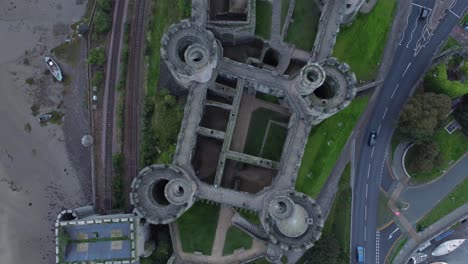 conwy medieval castle ruins birdseye aerial view above landmark battlements descending overhead