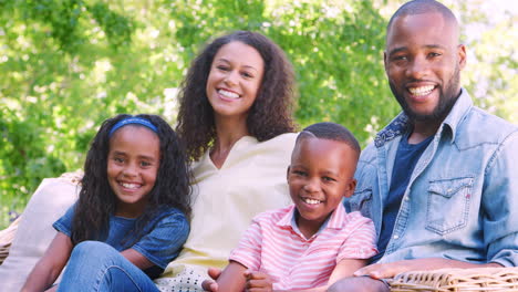 happy young black family sitting together in the garden