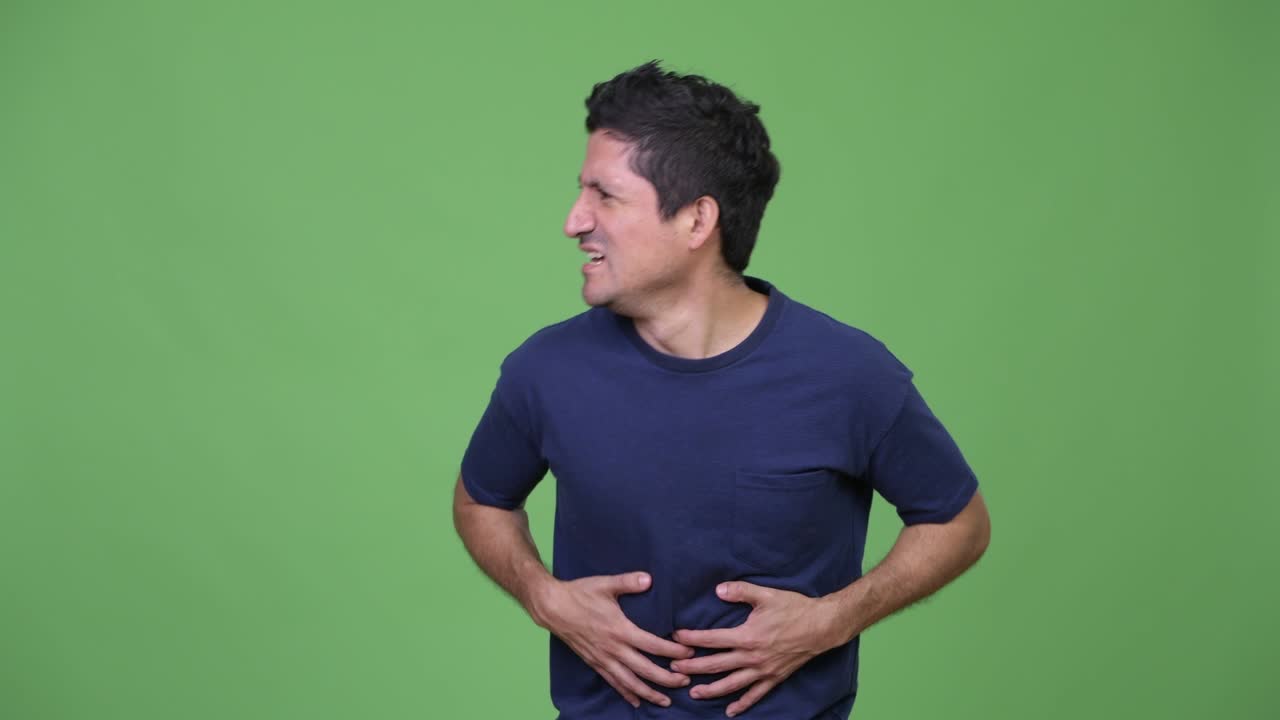 Stressed Hispanic man having stomach ache
