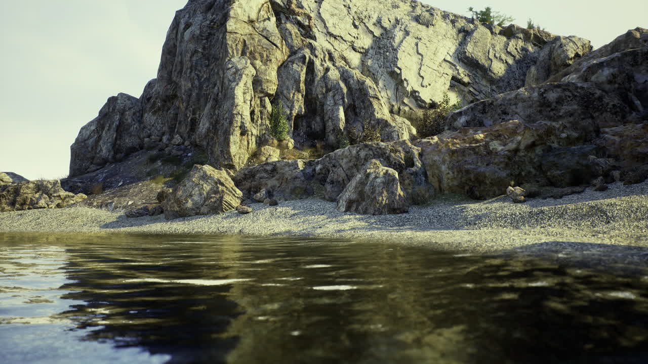 Rocky shoreline with calm water under cloudy sky in a serene location
