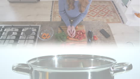 animación de zanahorias cayendo en la olla sobre una mujer caucásica cortando verduras en la cocina