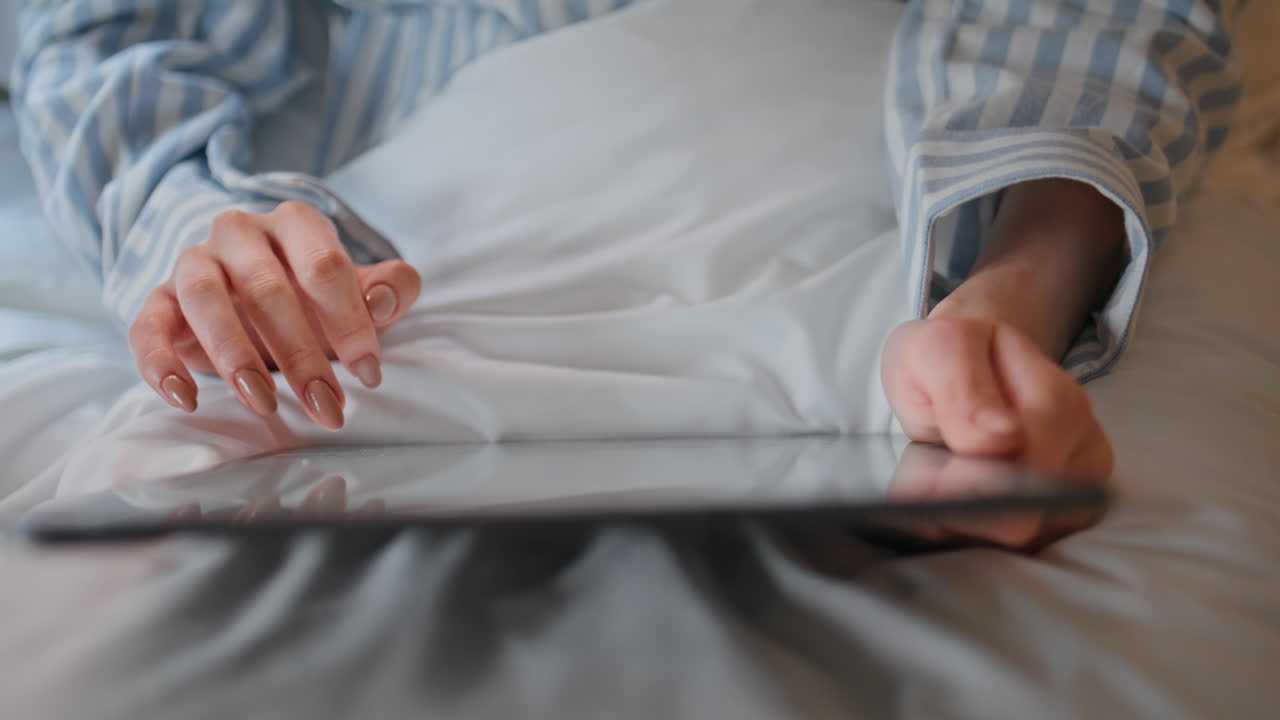 Professional woman touching tablet in morning bedroom closeup. Hands tapping