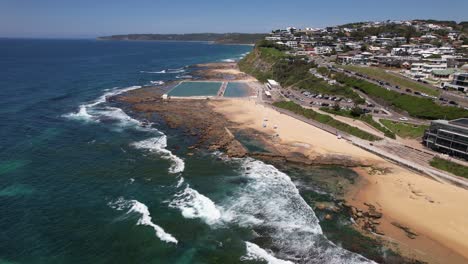 ocean waves at merewether beach in new south wales, australia - drone shot