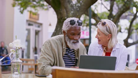 senior couple enjoying a cafe experience with technology