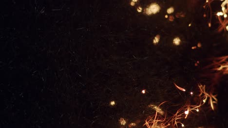 Hypnotic-steel-wool-burning-sparkles-in-darkness-round-bokeh