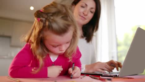 Mother-and-daughter-working-at-counter