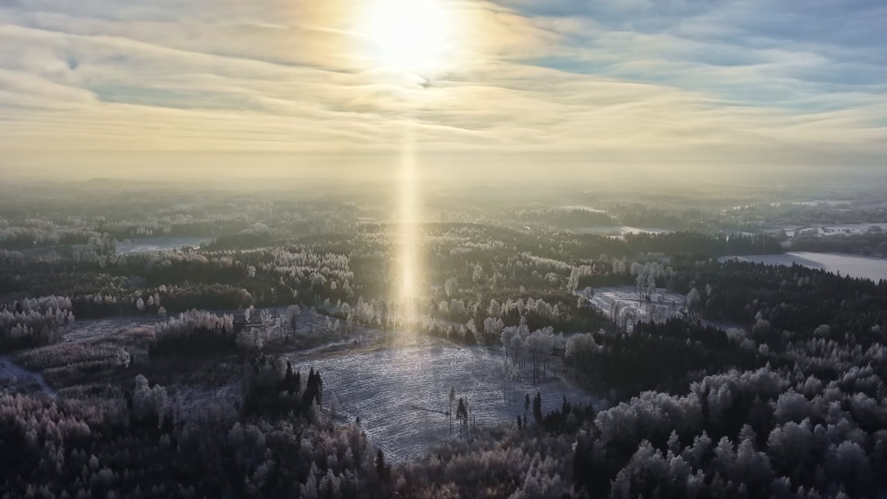 Bright Sun Shining Over Snow-covered Landscape And Pine Tree Forest In Winter. - aerial hyperlapse