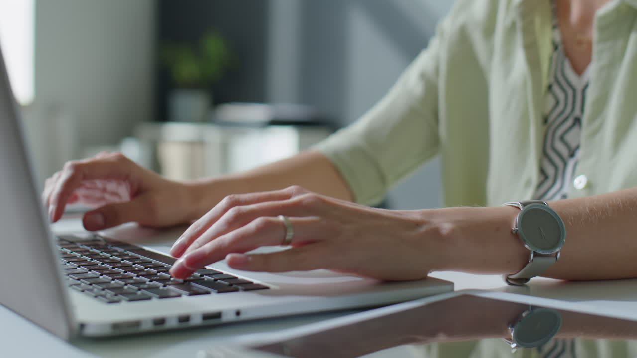 Hands of Businesswoman Working on Laptop at Office Desk