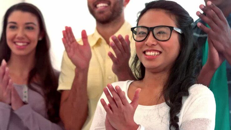 Casual business people clapping in a row