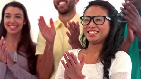 casual business people clapping in a row