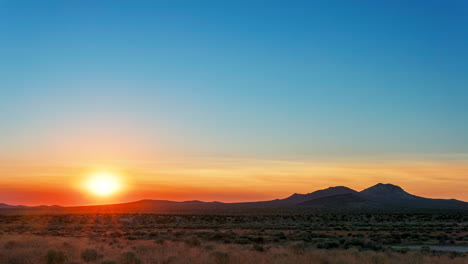 Stunningly-colorful-sunrise-over-the-Mojave-Desert-landscape-in-summer---time-lapse,-wide-angle,-static-view