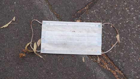 face mask carelessly thrown away in the street