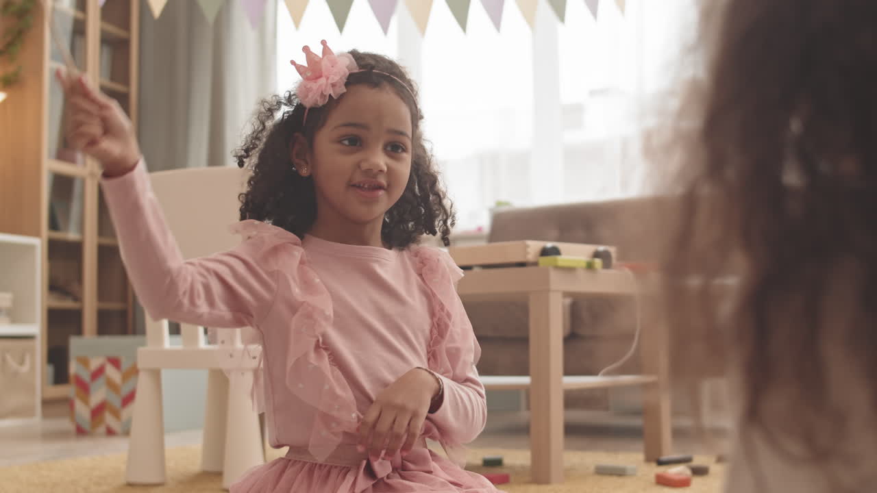 Mixed-Race Girl Playing with Toy Wand