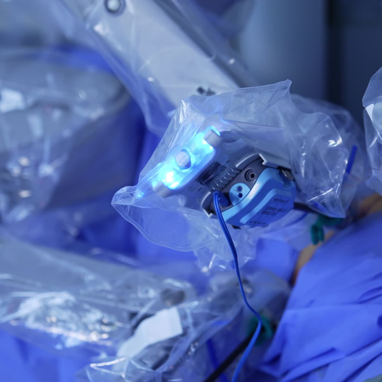 Manipulator active arm of robotic surgeon moving in the patient. Human is operated by the surgical machine close up