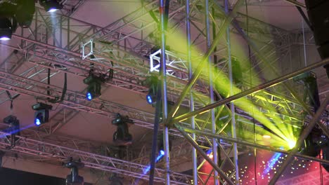 lighting equipment on the stage of the theater during the performance. the light rays from the spotlight through the smoke. red and yellow rays of light