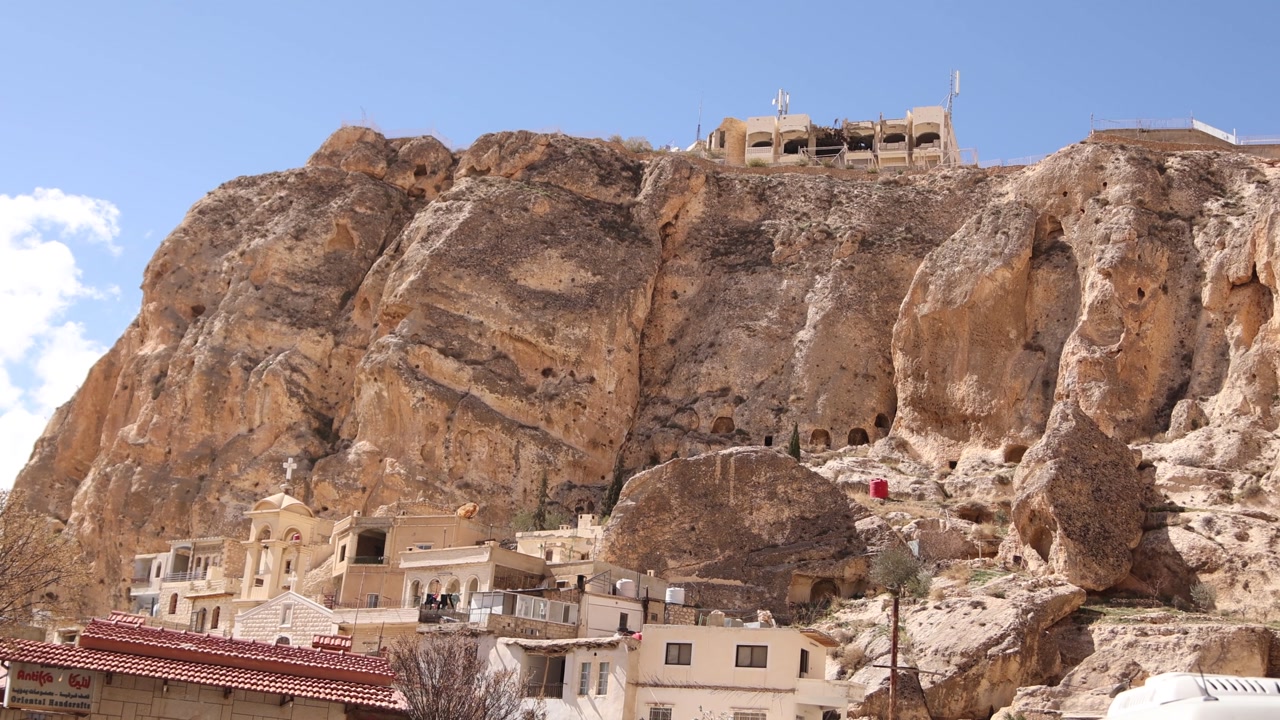 Exterior view of the Monastery in Ma'aloula, Syria, built into the massive rocky limestone cliffs. Famous Christian pilgrimage site in the mountains near Damascus