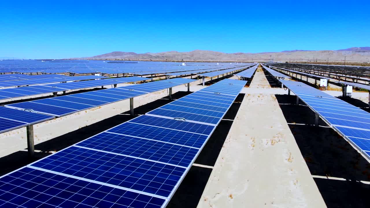 Giant solar photovoltaic sun power electricity generation farm low aerial drone fly in 4k in desert