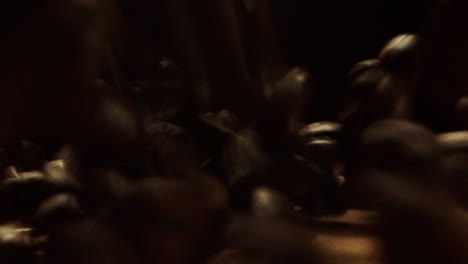 close camera movement over a wooden surface with coffee beans thrown on it