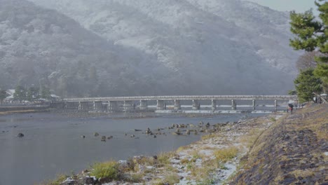 togetsu-kyo bridge at arashiyama mountain in kyoto after snowfall in winter