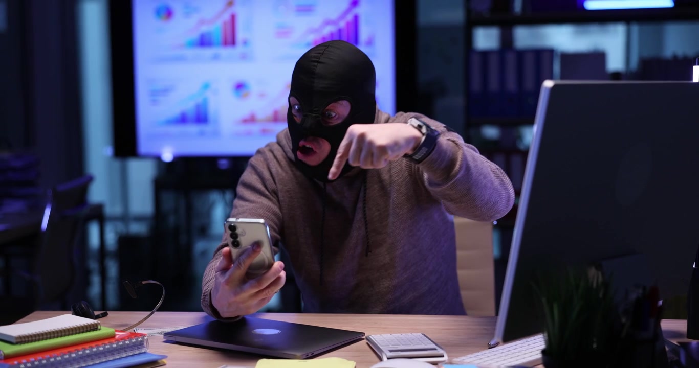 Emotional scammer in mask threatens user by video call in office