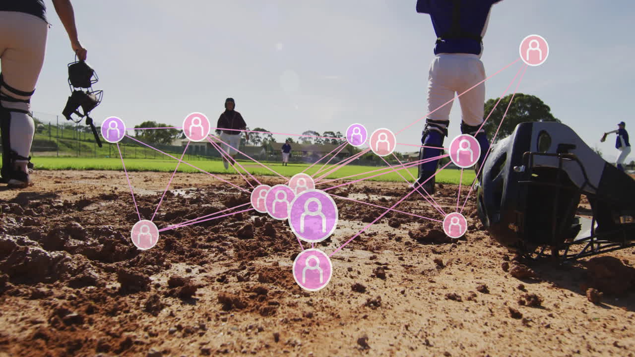 Female baseball team practicing on infield dirt, showing pink network overlay for sports analytics