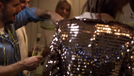 man serving champagne on the party