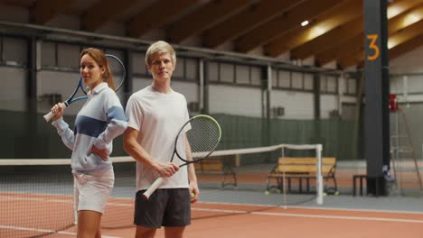 couple playing tennis indoor