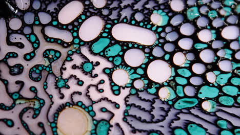 Abstract macro shot of vibrant liquid patterns with organic shapes in blue, white, and black