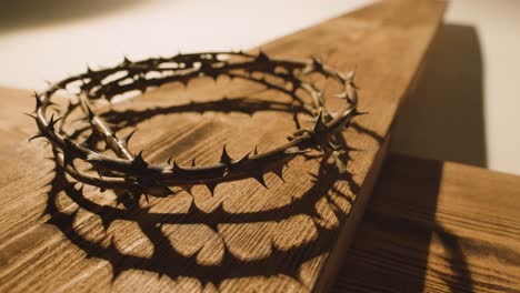 religious concept shot with crown of thorns and wooden cross in pool of light 2