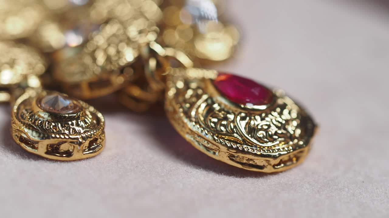 Close-up of Exquisite Gold Earrings with Ruby and Crystal Details