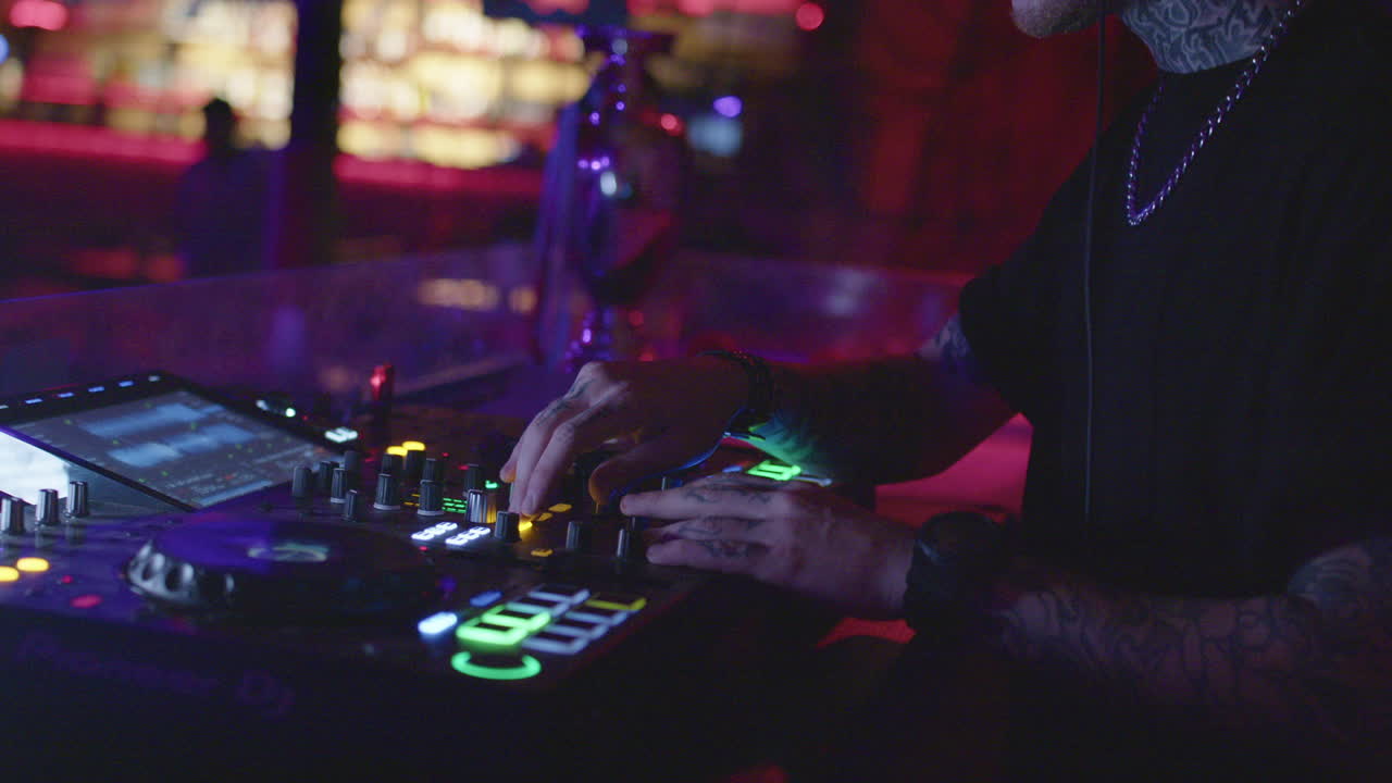 DJ performing under neon lights in a nightclub, energetic and lively atmosphere