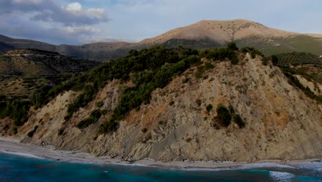 Beautiful-cape-with-rocks-and-pebbles-beach-surrounded-by-blue-turquoise-sea-in-Albania