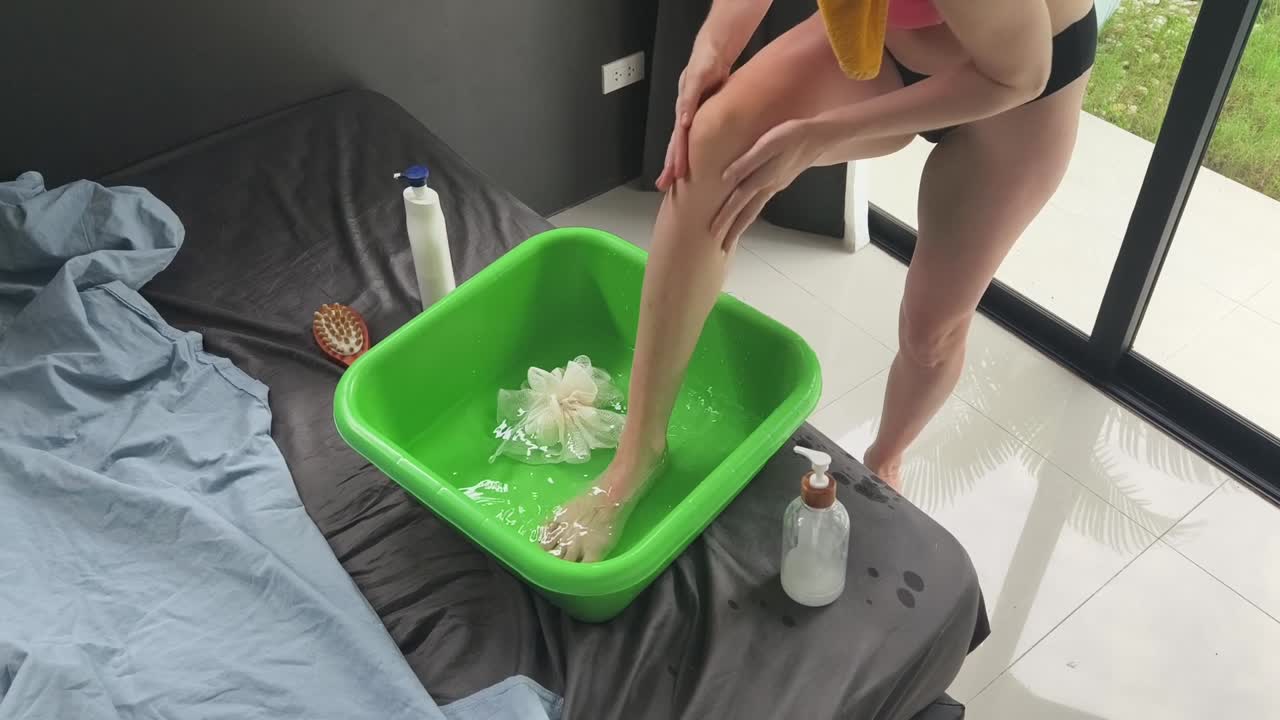 Woman soaking feet in a foot bath