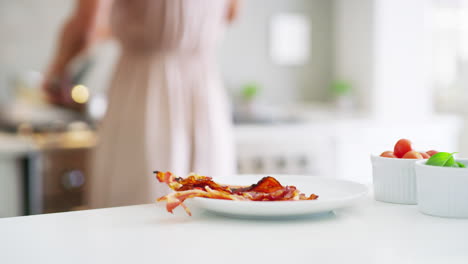 woman cooking breakfast with family dog
