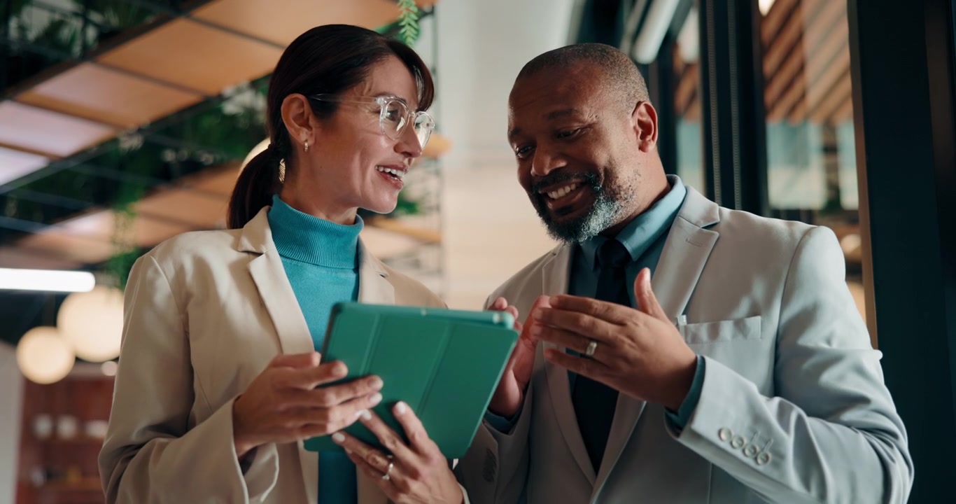 Business Colleagues High Five and Discuss Project on Tablet