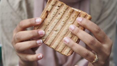 woman eating a delicious grilled sandwich