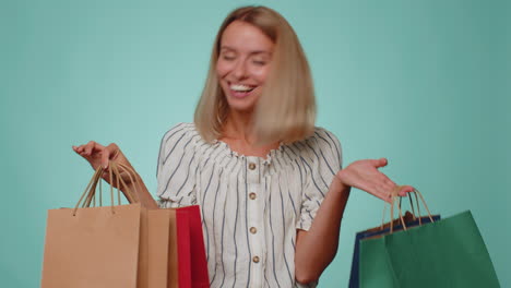 happy tourist woman showing shopping bags, advertising holidays discounts, amazed with low prices