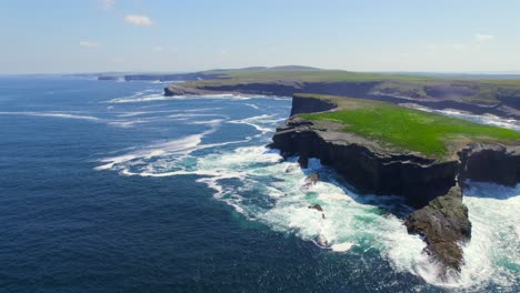 Aerial-reveal-shot-of-Kilkee-cliffs-towards-the-ocean