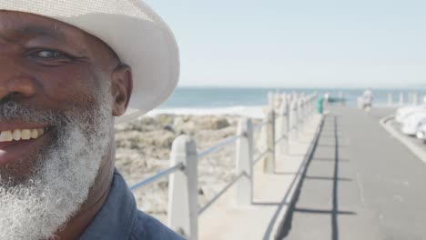 portrait of senior african american man on promenade by the sea, copy space, slow motion