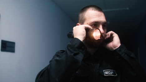 man in uniform searching on the hallway