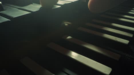 grand-piano-keyboard,-camera-moves-forewards-to-the-right,-closeup,-slow-motion,-black,-dark