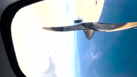 propeller airplane flying through the clouds, vertical video