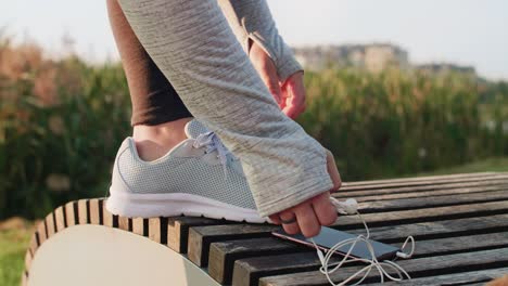 female runner tying his shoelaces